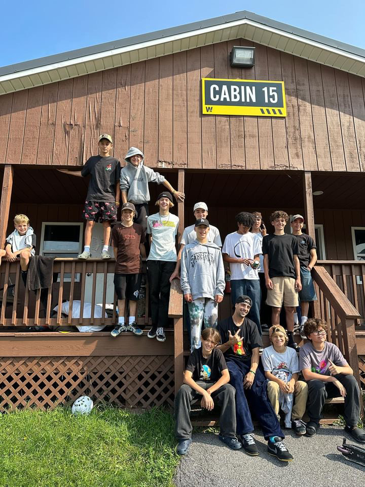 Group of people outside a cabin