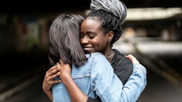 Two people embrace in a hug